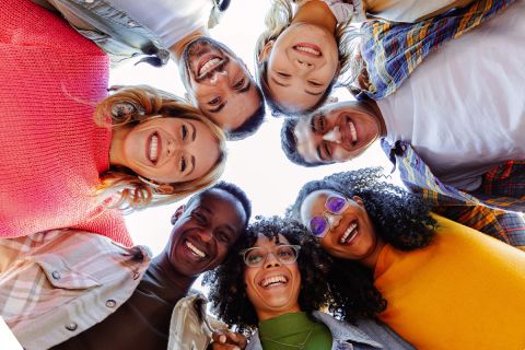 Photo looking up at a circle of friendly faces to illustrate the article Become All Things to All Men