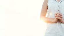 Photo of the torso of a woman standing with hands clasped to illustrate the article about 