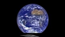 The Power and Greatness of God illustrated by photo of earth rising over the moon