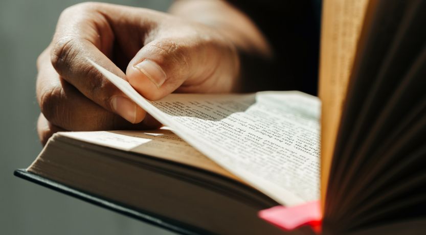 Photo of a person holding a Bible open, to illustrate the article